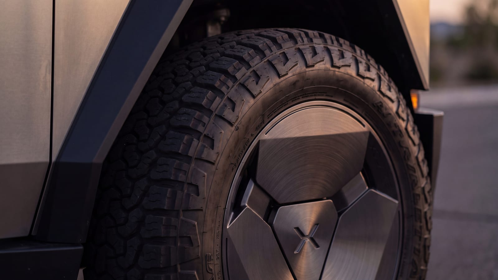 Forged wheel and all-terrain tire inside a Cybertruck front wheel arch, close to the fender liner (render)