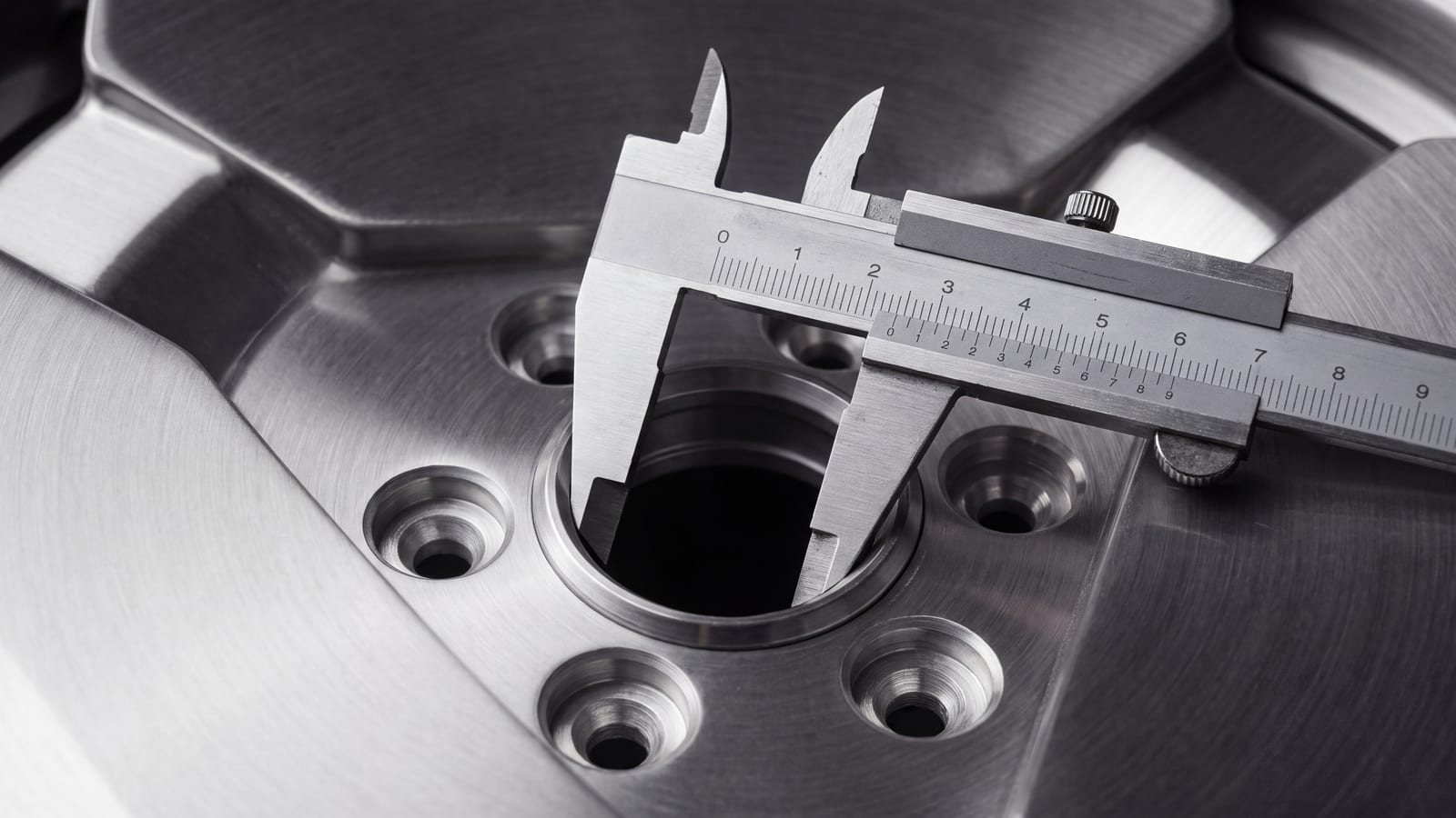 Vernier caliper measuring the center bore of a forged wheel between the lug holes (render)