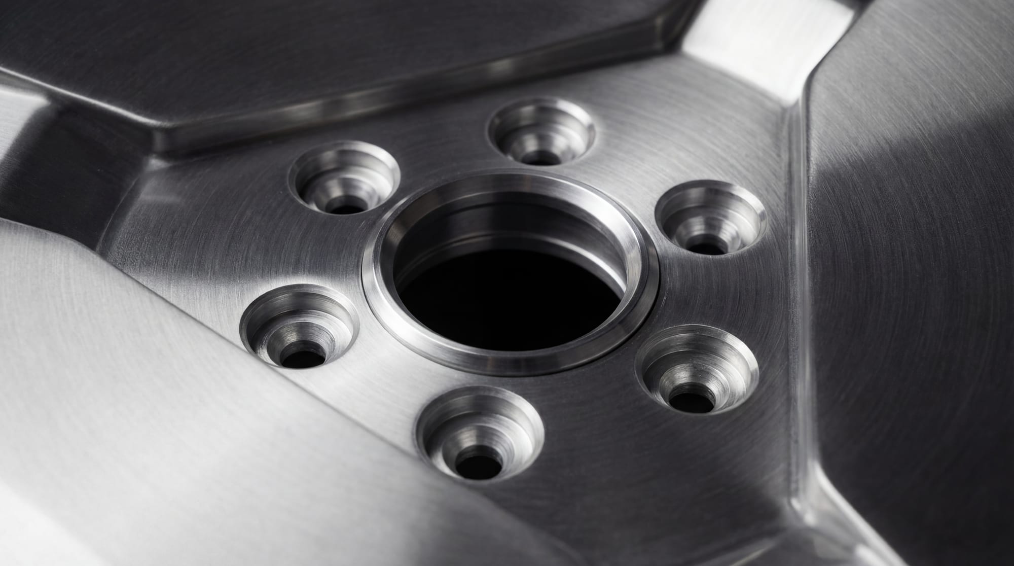 Close-up of a machined center bore and six lug seats on a forged wheel (render)